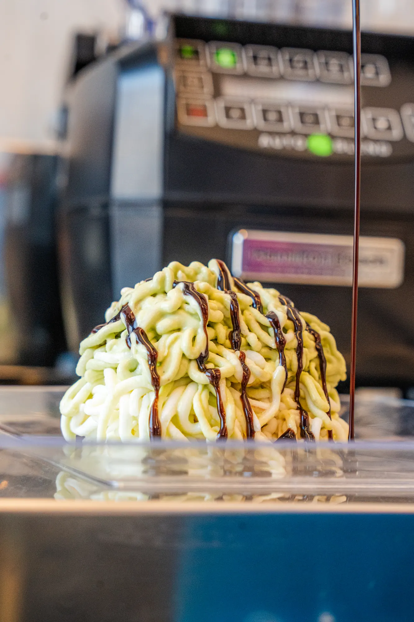 Ice cream pressed into spaghetti strands, drizzled with chocolate