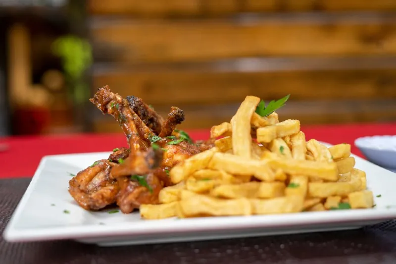 Grilled chicken wings with golden fries