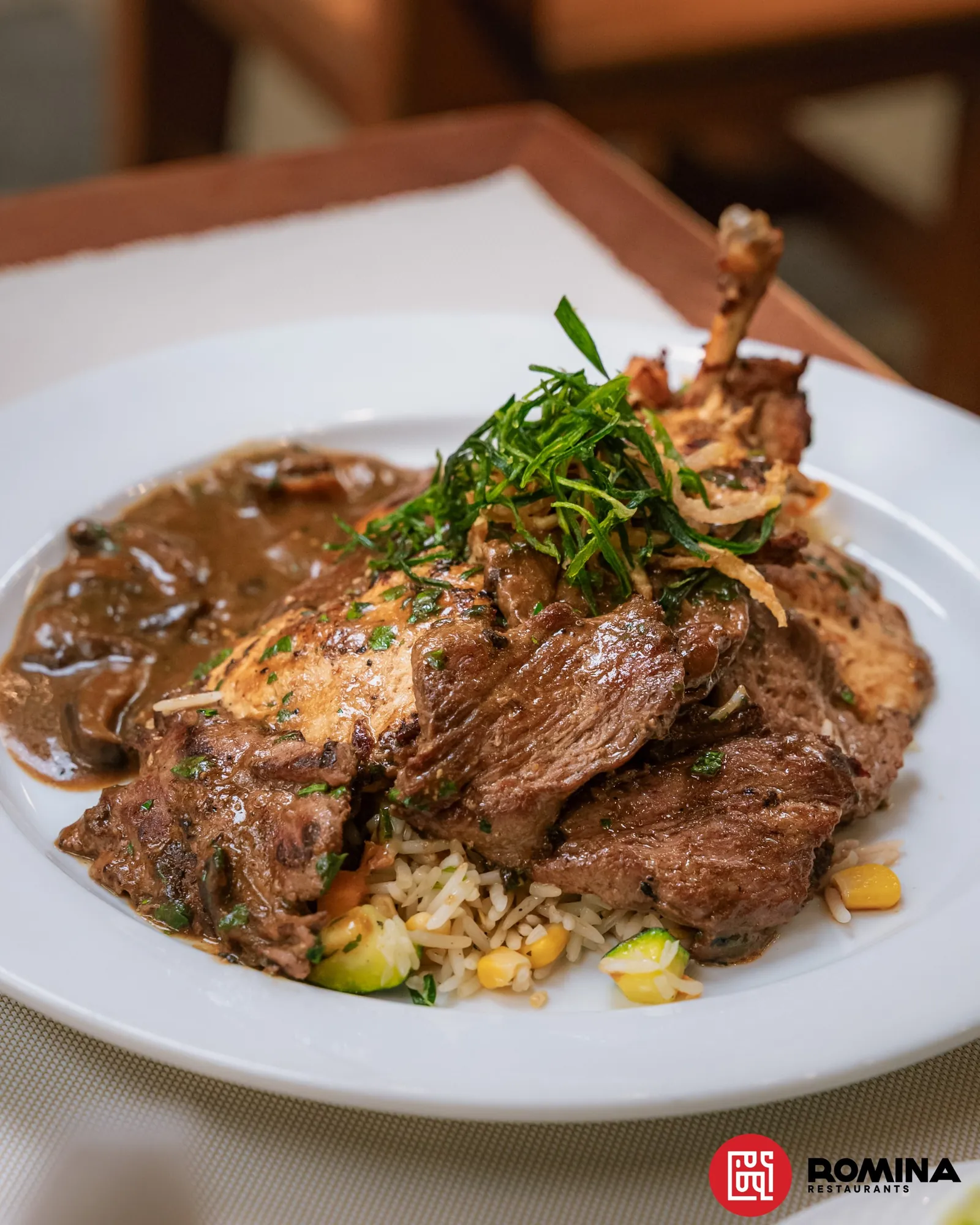 Mixed grill with rice, mushroom sauce and crispy greens