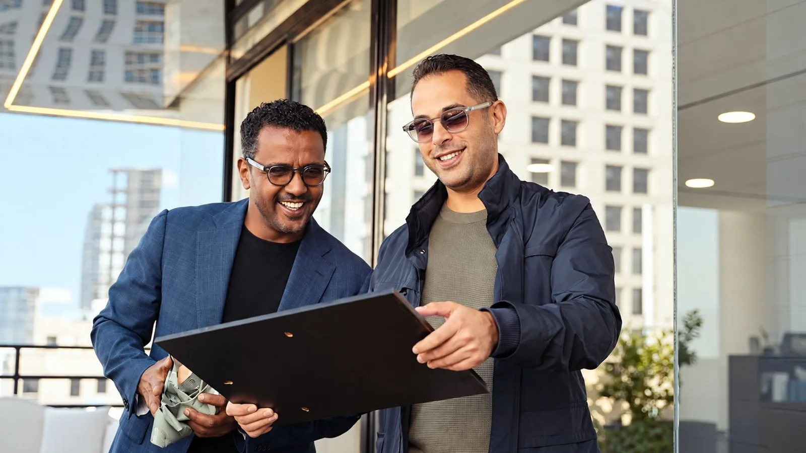 Two partners reviewing a presentation on a tablet