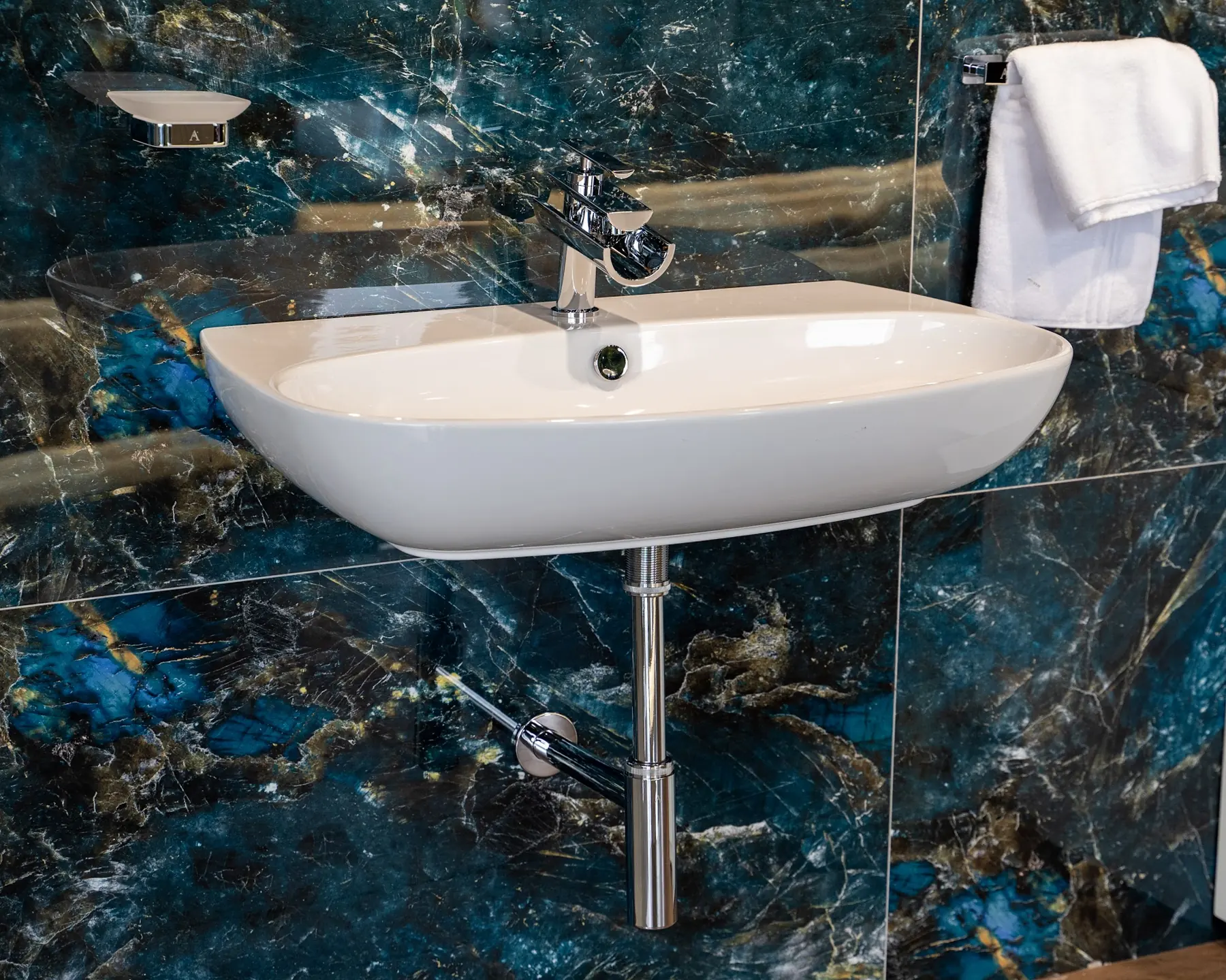A wall-hung basin on blue marble