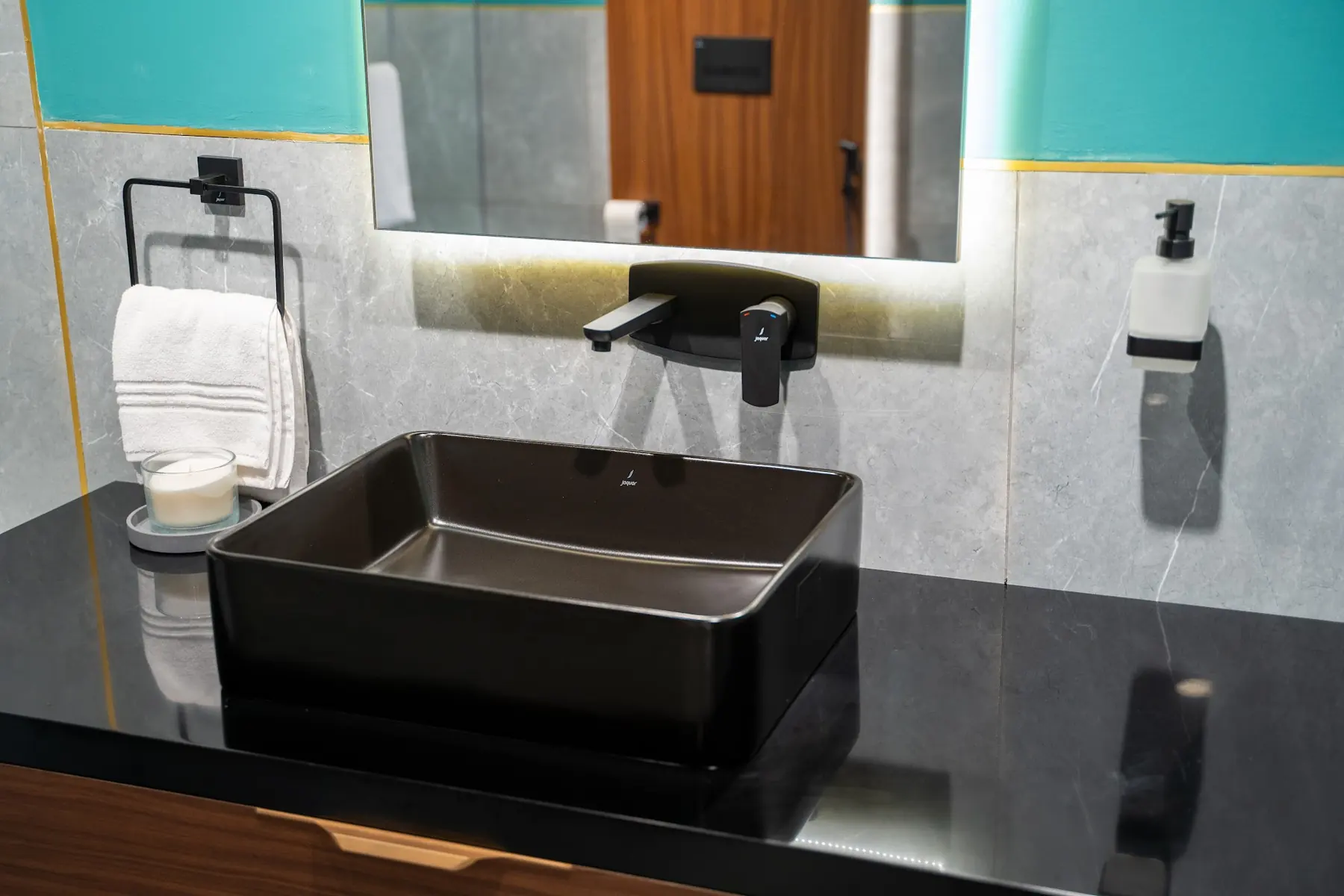 A matte black basin on a dark stone counter