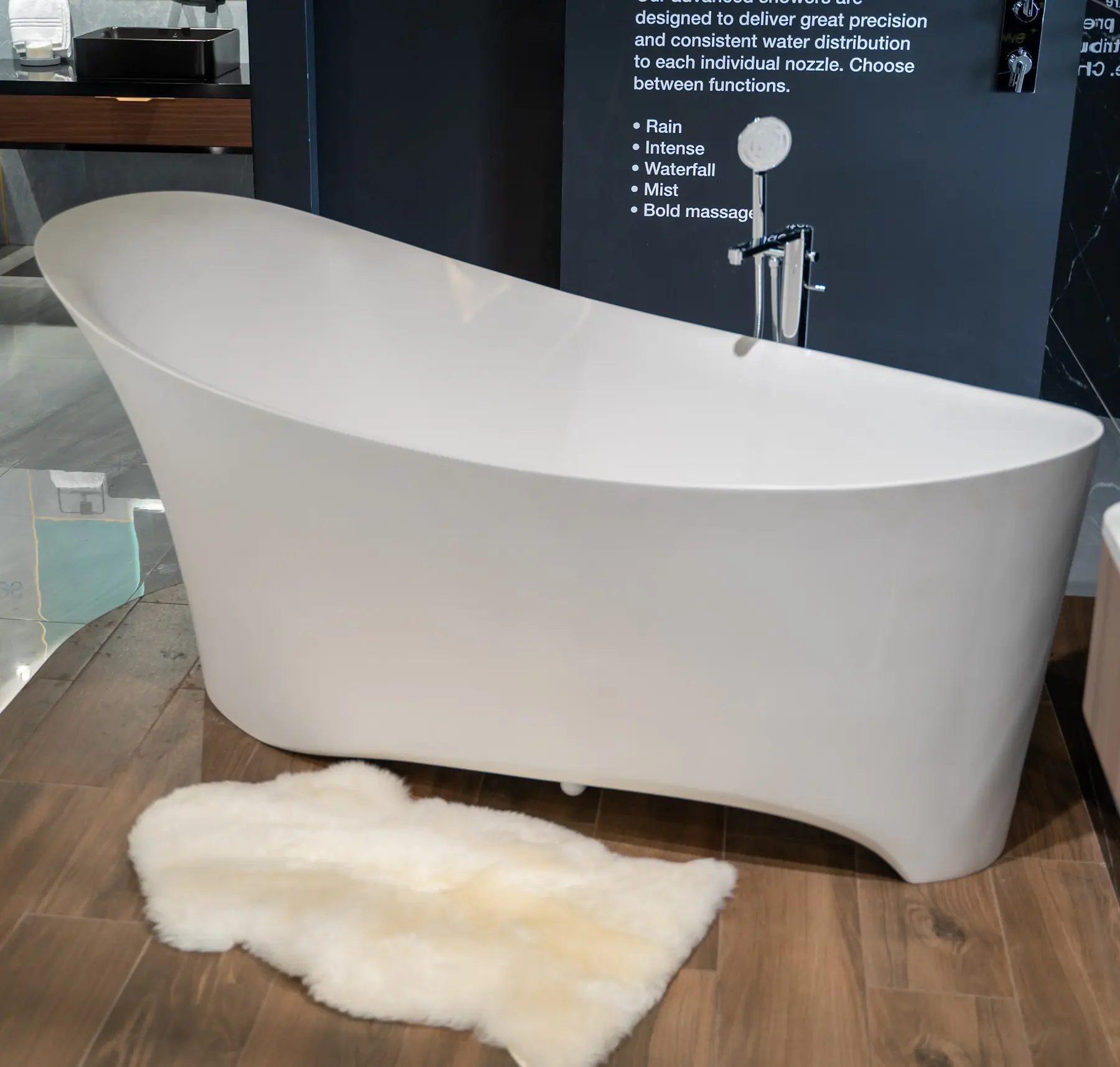 A slipper bathtub on a timber plinth with a sheepskin rug