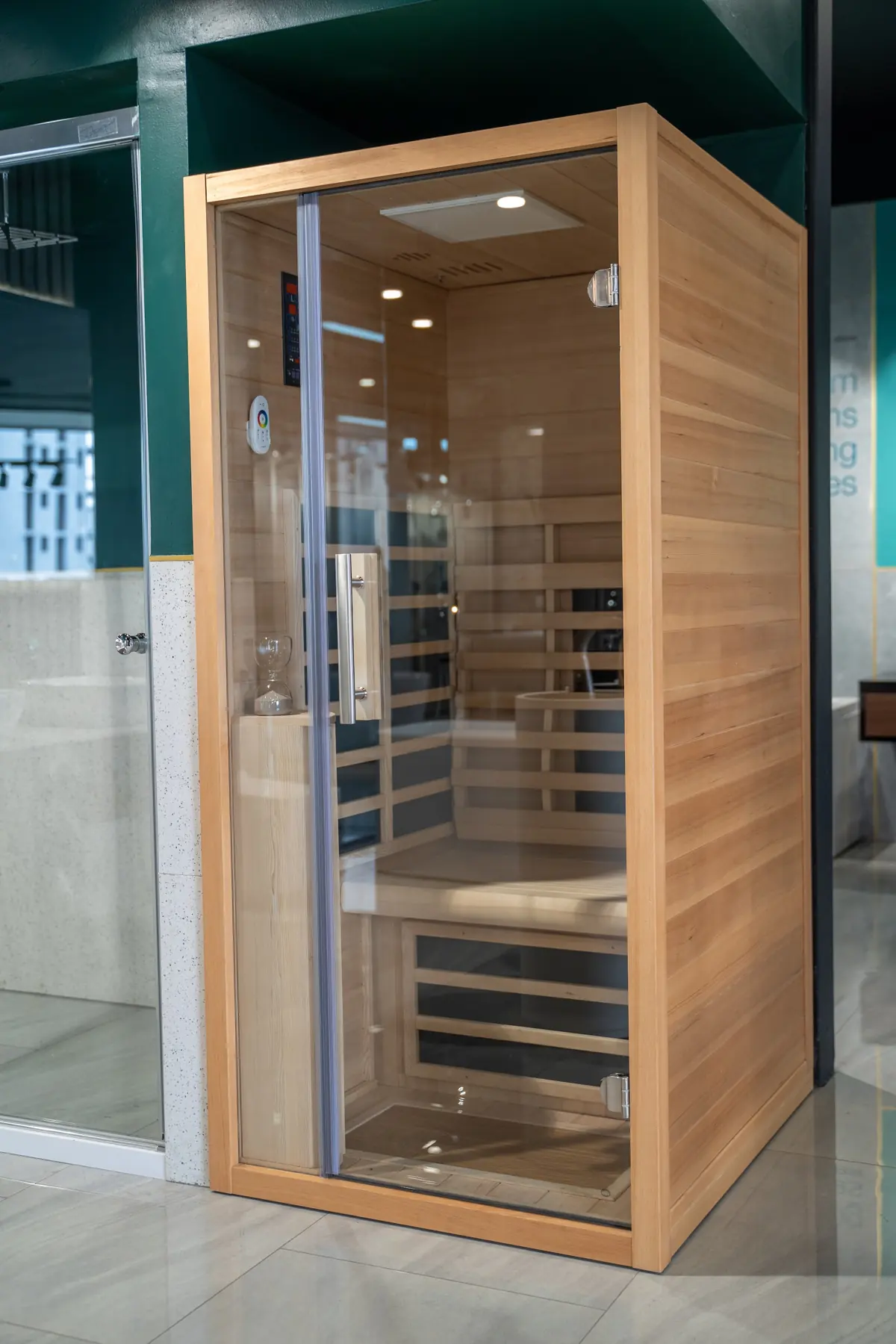 A wooden sauna cabin with a glass door
