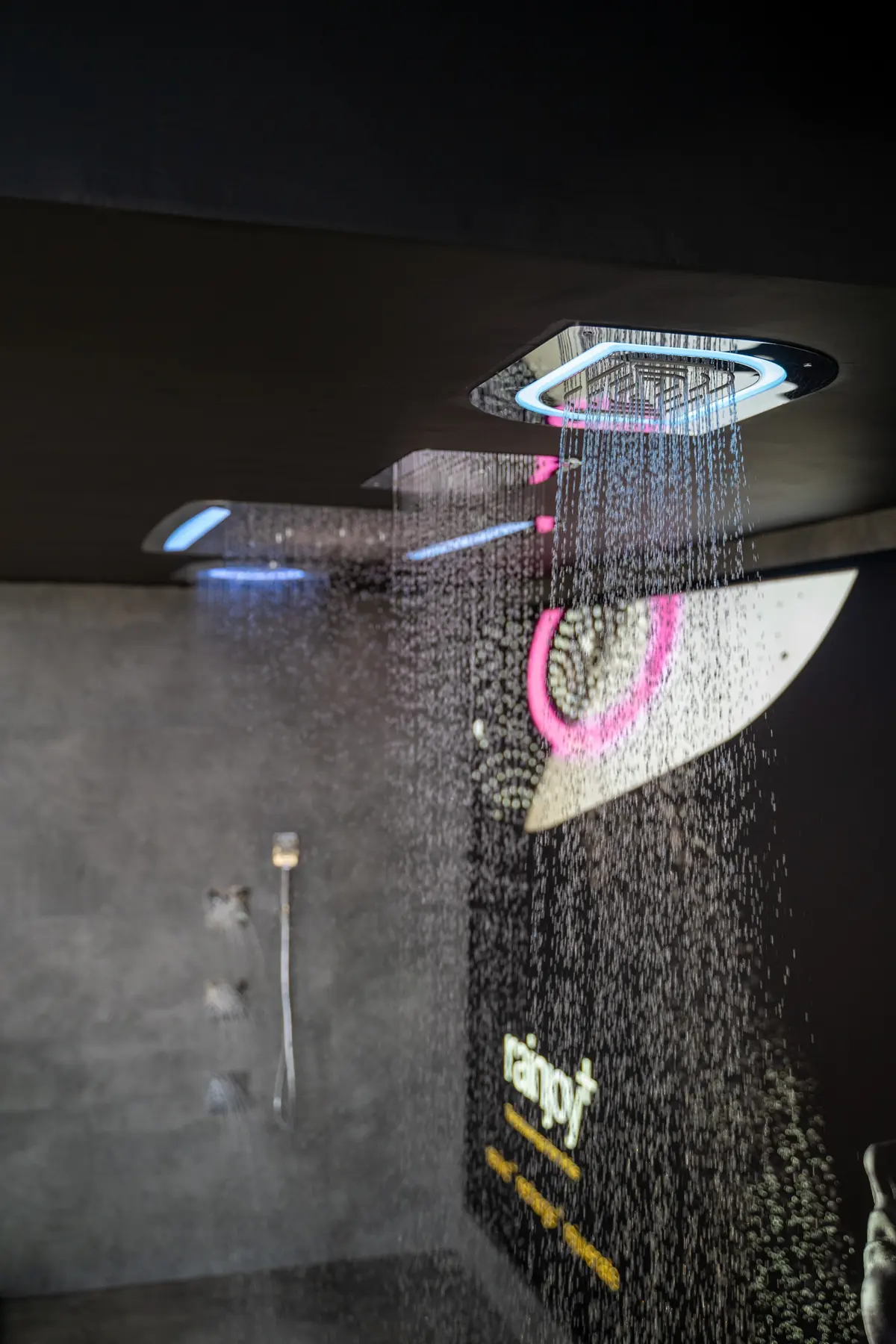 A ceiling-mounted Rainjoy shower with coloured light
