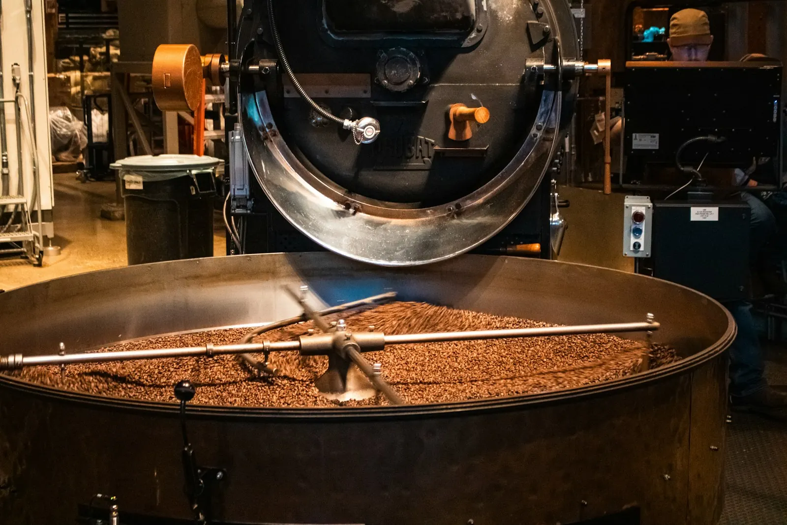 Freshly roasted coffee beans turning in a roaster cooling tray